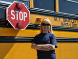 Driver standing beside bus