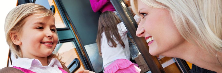 Mother helping daughter on to the bus